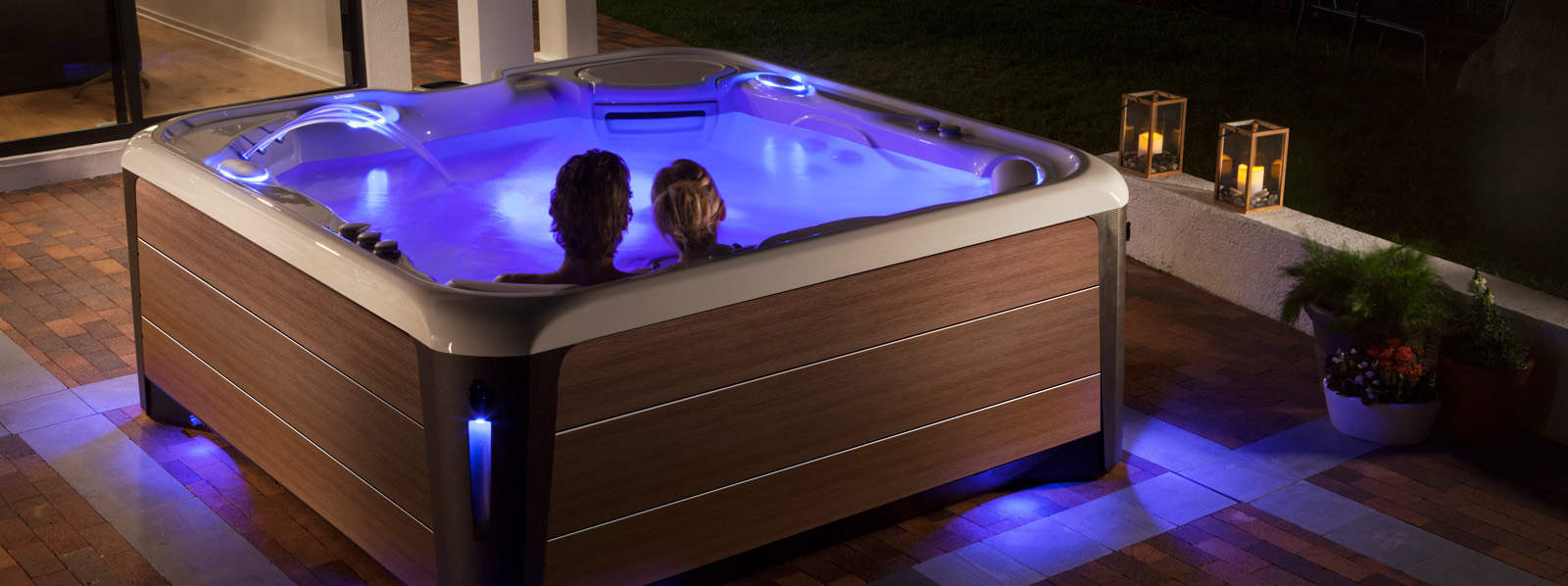 Hot Spring Spas Highlife Collection Hot Tub | Couple in hot tub in their Backyard